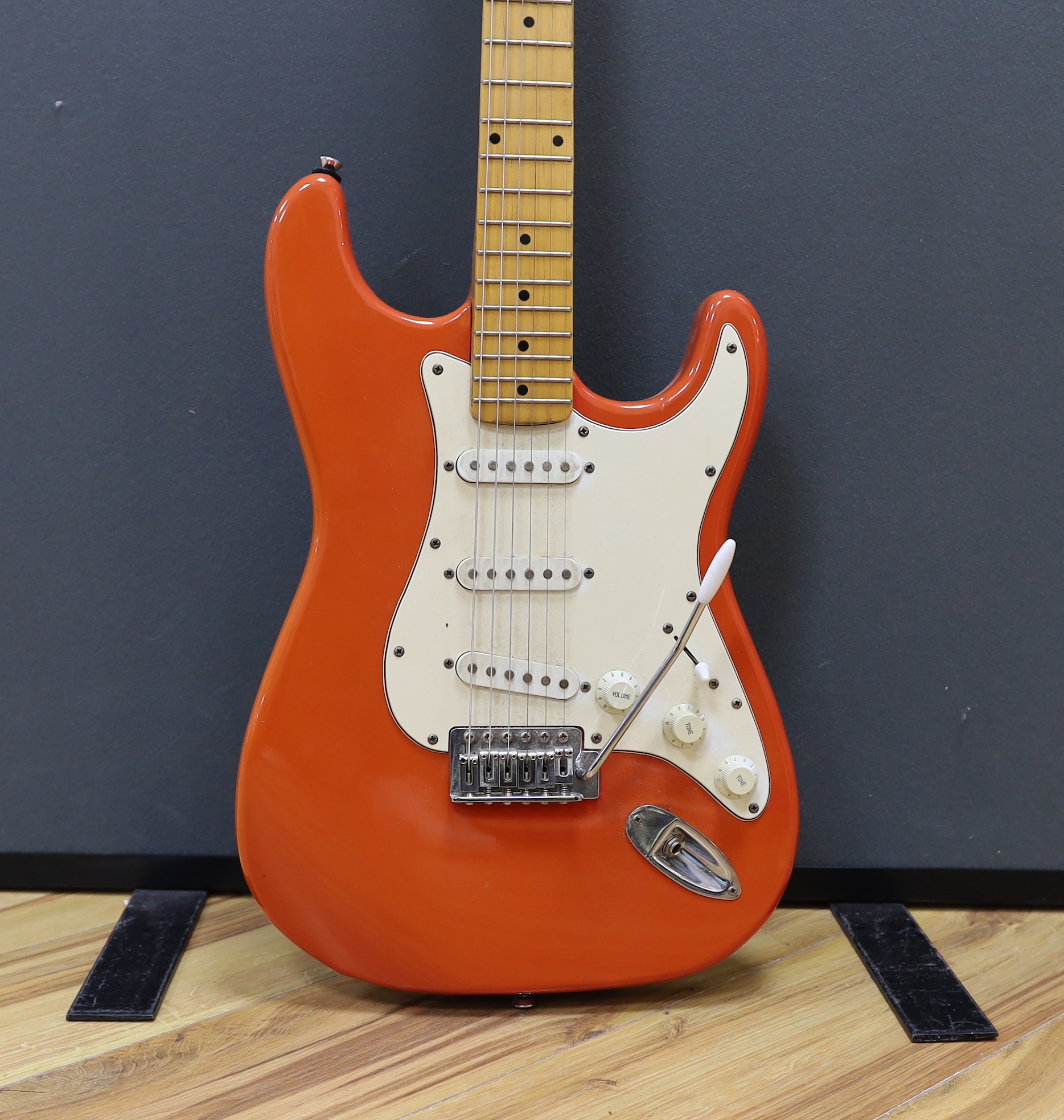 A JCX Stargazer electric guitar with maple neck and orange lacquered body